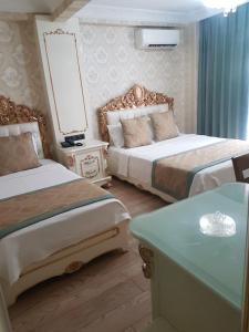 Postel nebo postele na pokoji v ubytování Best Town Hotel