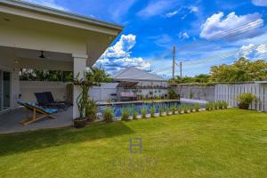 a backyard of a house with a swimming pool at Cozy Modern 3 Bedroom Pool Villa L70 in Hua Hin