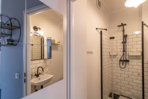 a bathroom with a shower and a sink at Apartamenty Wójcik Loft in Gdynia +65 photos