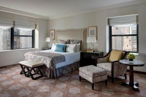 a hotel room with a bed and a chair at Lotte New York Palace in New York +36 photos