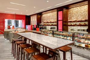 a restaurant with a large table and chairs and a bakery at Lotte New York Palace in New York