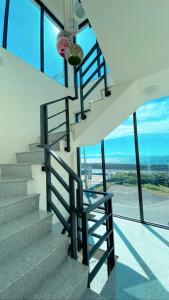 a staircase in a house with glass windows at Coral Island in Xiaoliuqiu