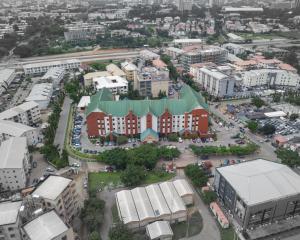 an aerial view of a city with buildings and cars at Hawthorn Suites by Wyndham Abuja in Abuja