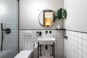 a bathroom with a sink and a mirror at The Modernist Thessaloniki in Thessaloniki