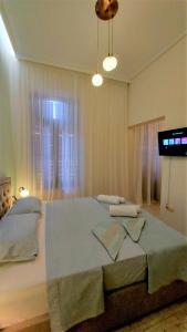 Postel nebo postele na pokoji v ubytování Theasis Athens