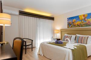 Postel nebo postele na pokoji v ubytování Hotel Jardim