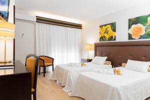 Postel nebo postele na pokoji v ubytování Hotel Jardim