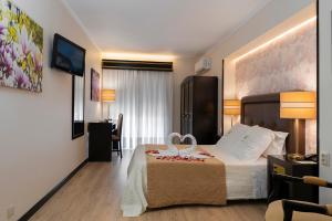 Postel nebo postele na pokoji v ubytování Hotel Jardim