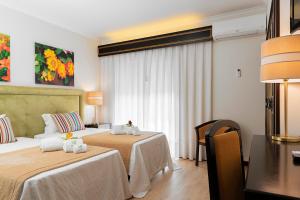 Postel nebo postele na pokoji v ubytování Hotel Jardim