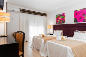 Postel nebo postele na pokoji v ubytování Hotel Jardim