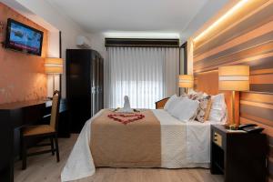 Postel nebo postele na pokoji v ubytování Hotel Jardim
