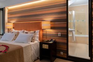 Postel nebo postele na pokoji v ubytování Hotel Jardim