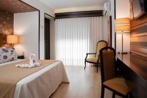 Postel nebo postele na pokoji v ubytování Hotel Jardim