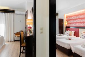 Postel nebo postele na pokoji v ubytování Hotel Jardim