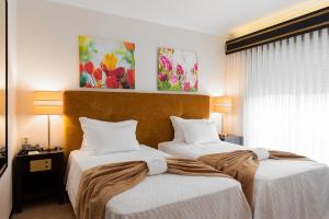 Postel nebo postele na pokoji v ubytování Hotel Jardim