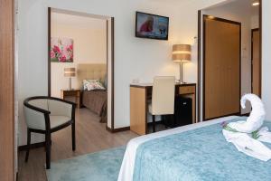 Postel nebo postele na pokoji v ubytování Hotel Jardim