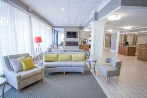 a living room with two chairs and a couch at Holiday Inn Bloomington Airport South-Mall Area by IHG in Bloomington