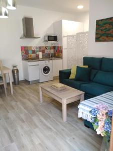 a living room with a couch and a table at Apartamento Laila,Sevilla, in Alcalá de Guadaira