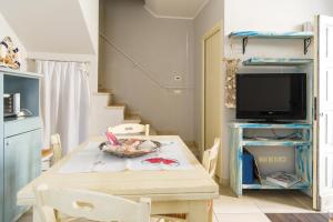 a dining room with a table and a tv at Cà Tabachera in Rimini