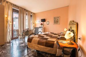 a hotel room with a bed and a desk at Soggiorno Fortezza Fiorentina in Florence