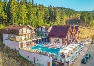 an aerial view of a house with a swimming pool at Karpatski Hotel & Spa in Bukovel