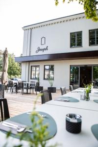 a restaurant with tables and chairs in front of a building at Hotel Restaurant Joseph in Bruckneudorf