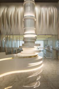 a lobby with a large stack of lights in a building at Green Suites Boutique Hotel in Athens