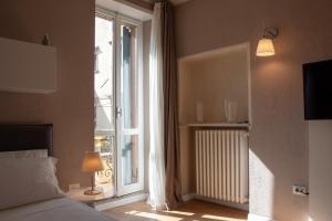 Posteľ alebo postele v izbe v ubytovaní Domus Suites Verona