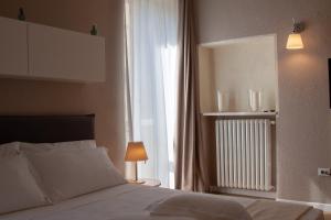 Posteľ alebo postele v izbe v ubytovaní Domus Suites Verona