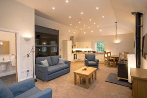 a living room with a couch and chairs and a table at Netherby Hall in Carlisle