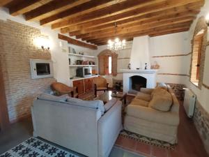 a living room with a couch and a fireplace at La Aldaba del siglo XX in Alcañizo