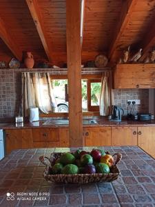 a bowl of fruit on a table in a kitchen at Aretis sea view house in Pachyammos +27 photos