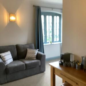 a living room with a couch and a table at The Mooring Post in Gloucester