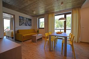 a dining room and living room with a table and chairs at Vetrnik Depandance Hotelu Jirinka in Dolní Morava