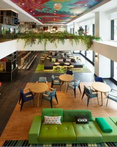 a view of a lobby with tables and chairs at citizenM Kuala Lumpur Bukit Bintang in Kuala Lumpur
