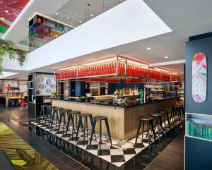 a bar at a restaurant with stools at citizenM Kuala Lumpur Bukit Bintang in Kuala Lumpur