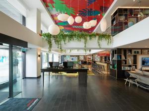 a library with a desk in the middle of a room at citizenM Kuala Lumpur Bukit Bintang in Kuala Lumpur