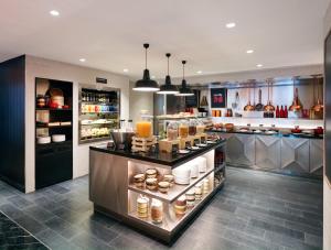 a kitchen with a counter with food on it at citizenM Kuala Lumpur Bukit Bintang in Kuala Lumpur