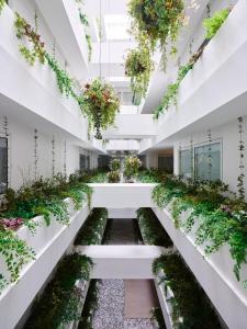 an internal courtyard of a building with plants at citizenM Kuala Lumpur Bukit Bintang in Kuala Lumpur
