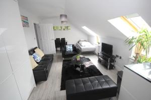 a living room with a couch and a table at Holden Court Apartments - Apt 6 in West Drayton