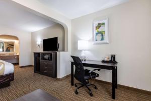 a hotel room with a desk and a bed at Quality Inn Southaven - Memphis South in Southaven