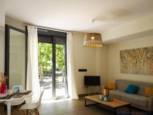 a living room with a couch and a table at ALAMEDA SQUARE APARTMENT in Seville
