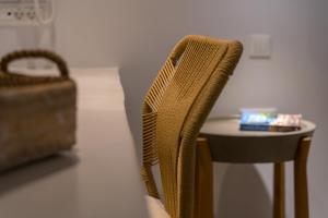 a chair next to a small table with a box on it at Adonis Hotel Studios & Apartments in Naousa