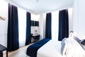 A bed or beds in a room at Villa Eugenia Boutique Hotel