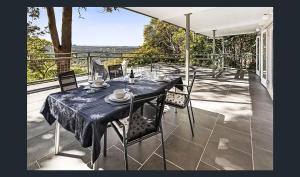 a table and chairs on a balcony with a view at Potters Place Montville in Montville