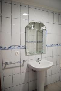 a bathroom with a sink and a mirror at Residência Machado in Horta