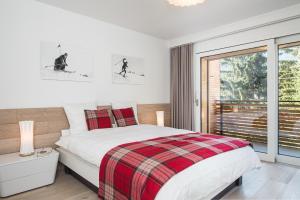 a bedroom with a bed and a large window at Ascot-Zermatt in Zermatt