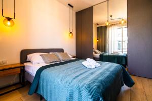 Posteľ alebo postele v izbe v ubytovaní VIP Apartamenty Butikowa