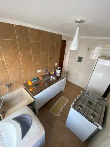 a small bathroom with a sink and a washing machine at Boss Apartments in Paranoá