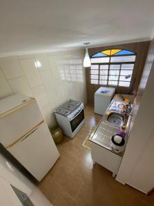 an overhead view of a kitchen with a stove and refrigerator at Boss Apartments in Paranoá
